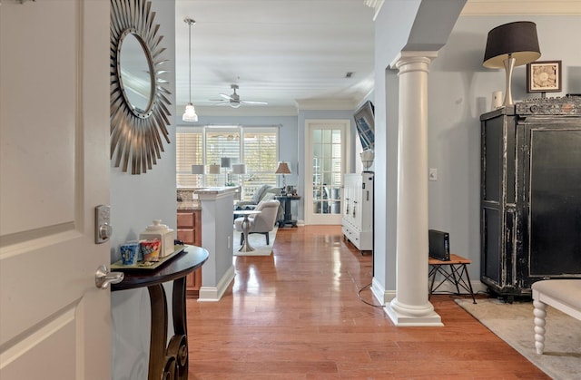 entrance foyer with ceiling fan, ornamental molding, light hardwood / wood-style flooring, and decorative columns