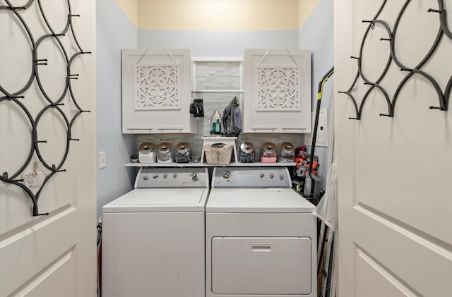 laundry area featuring washer and dryer and cabinets