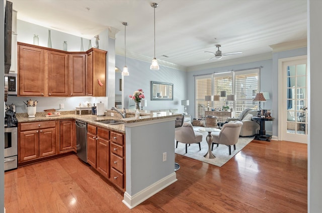 kitchen featuring light hardwood / wood-style floors, kitchen peninsula, stainless steel appliances, ceiling fan, and decorative light fixtures