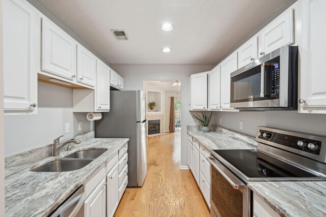 1505 Blaze Ln, Charleston, SC 29412 - kitchen with stainless steel appliances, light wood-type flooring, white cabinets, ceiling fan, and recessed lighting