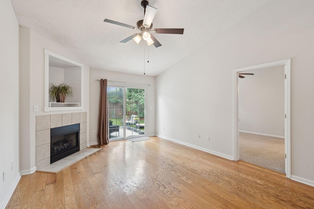 1505 Blaze Ln, Charleston, SC 29412 - unfurnished living room featuring a fireplace, a ceiling fan, wood finished floors, and a textured ceiling