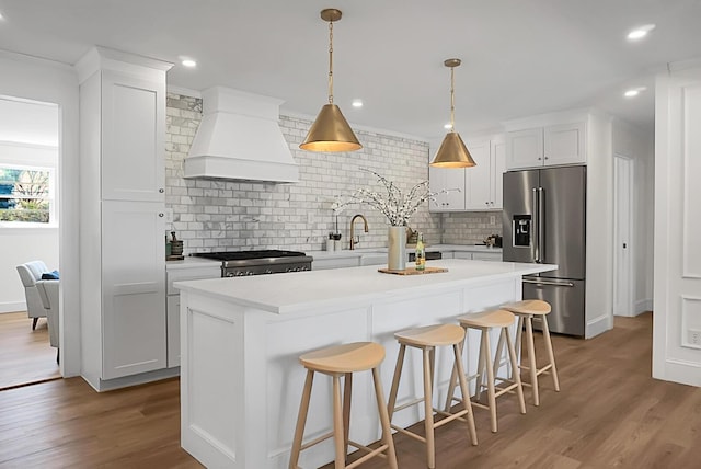 5259 Hartford Cir N, Charleston, SC 29405 - kitchen featuring high end fridge, premium range hood, range, backsplash, and recessed lighting