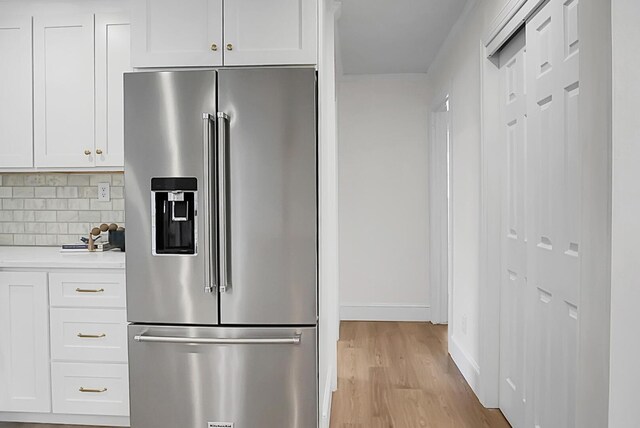 5259 Hartford Cir N, Charleston, SC 29405 - kitchen featuring stainless steel fridge, light countertops, light wood-style floors, tasteful backsplash, and white cabinets