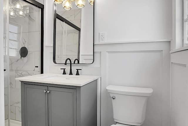 5259 Hartford Cir N, Charleston, SC 29405 - bathroom featuring toilet, vanity, a marble finish shower, and a chandelier