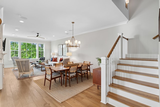 dining space featuring a ceiling fan, light wood-type flooring, stairway, ornamental molding, and recessed lighting