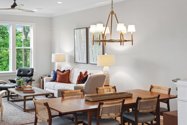living room featuring ornamental molding, ceiling fan with notable chandelier, and recessed lighting