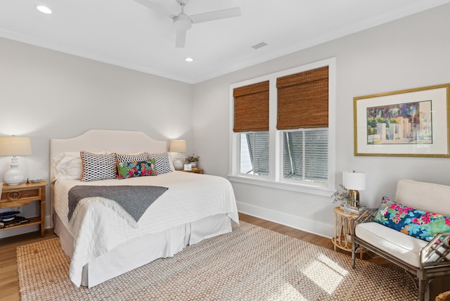 bedroom featuring ceiling fan, visible vents, wood finished floors, baseboards, and recessed lighting