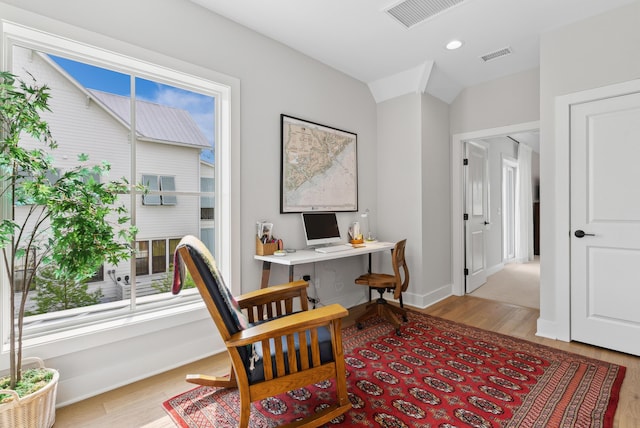 office featuring baseboards, visible vents, and light wood-style flooring