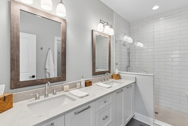 full bathroom with double vanity, a sink, and a walk in shower