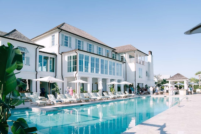 pool with a gazebo and a patio area