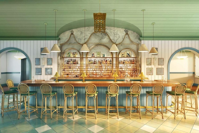 bar featuring tile patterned floors and indoor wet bar