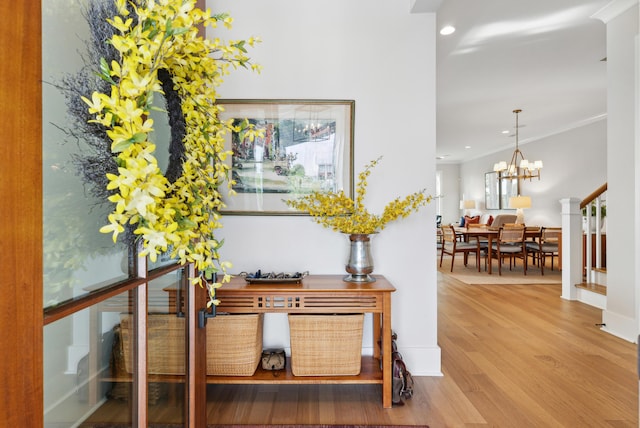 corridor featuring recessed lighting, a chandelier, and wood finished floors