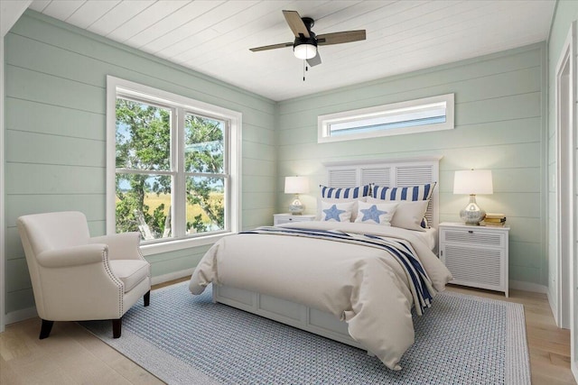 bedroom with wooden ceiling, ceiling fan, multiple windows, and light wood-type flooring