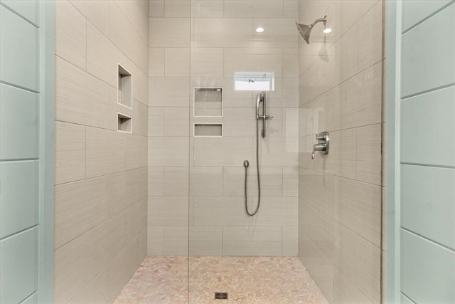 bathroom with a tile shower