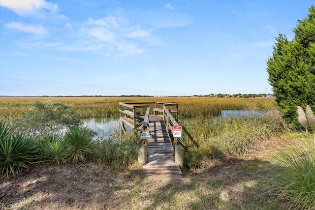 view of dock featuring a water view and a rural view