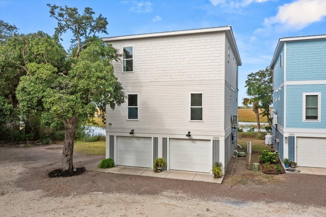 rear view of house featuring a garage