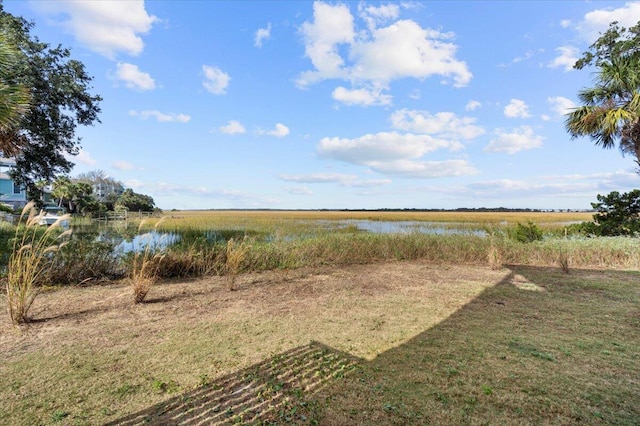 view of yard featuring a rural view and a water view