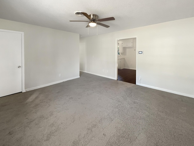 unfurnished room featuring ceiling fan, a textured ceiling, and dark colored carpet