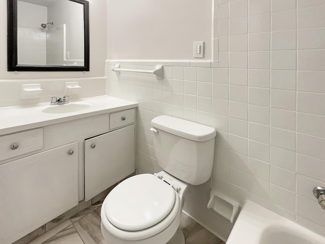 full bathroom with  shower combination, vanity, tile walls, and toilet