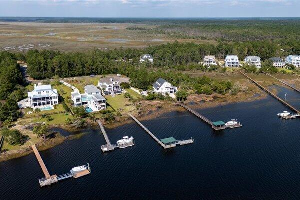view of property location with a forest and a large body of water