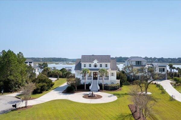 view of front of home with a front lawn and stairway