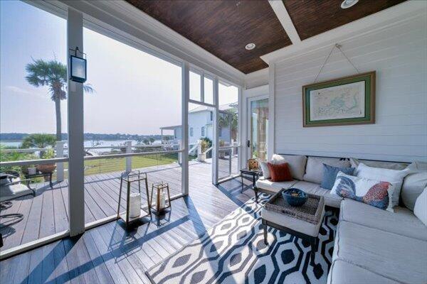 sunroom with wood ceiling, hardwood / wood-style flooring, outdoor lounge area, ornamental molding, and wooden walls