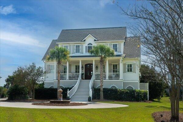 view of front of property featuring stairs, a porch, and a front yard