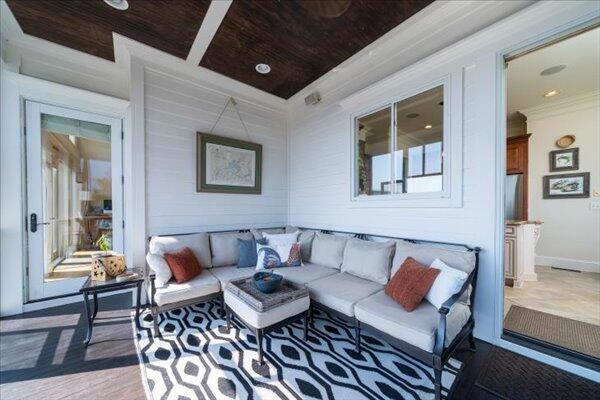living room with crown molding and wooden ceiling
