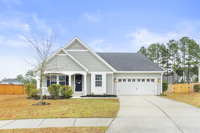 view of front of house with a garage and a front lawn