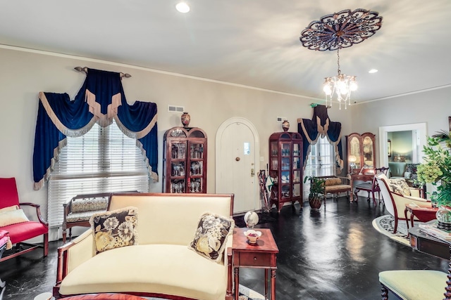 living room featuring visible vents, an inviting chandelier, and ornamental molding