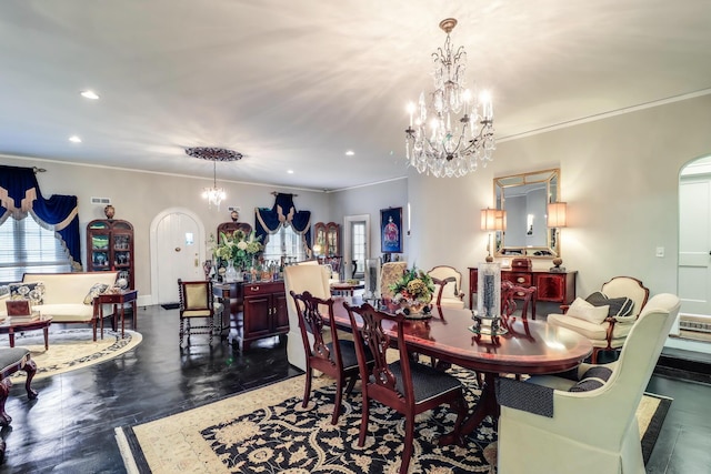 dining area with wood finished floors, a chandelier, arched walkways, ornamental molding, and recessed lighting