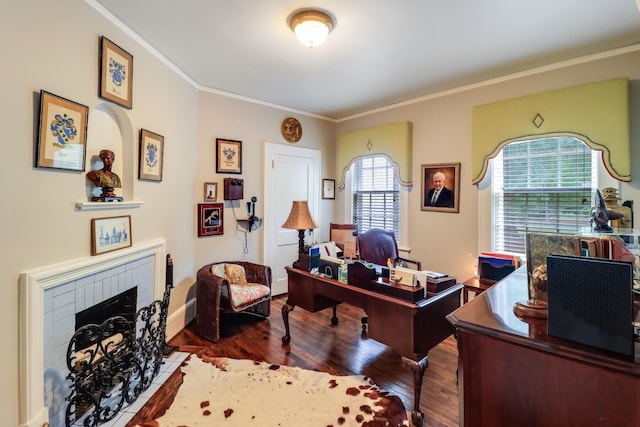 office featuring a brick fireplace, wood finished floors, and ornamental molding