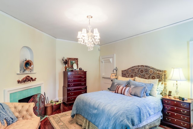 bedroom featuring wood finished floors, a chandelier, and ornamental molding