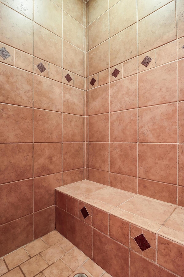 full bath featuring a tile shower