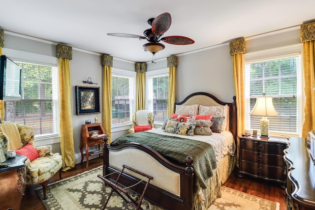bedroom featuring a ceiling fan, crown molding, and wood finished floors