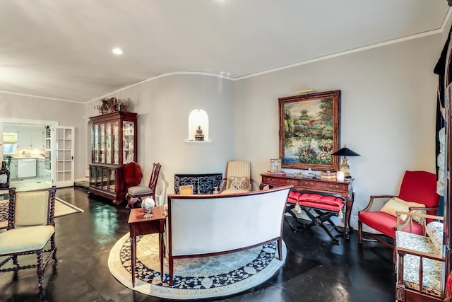 sitting room featuring concrete floors, recessed lighting, and ornamental molding