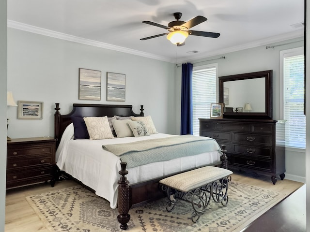bedroom featuring light wood-type flooring, crown molding, and visible vents