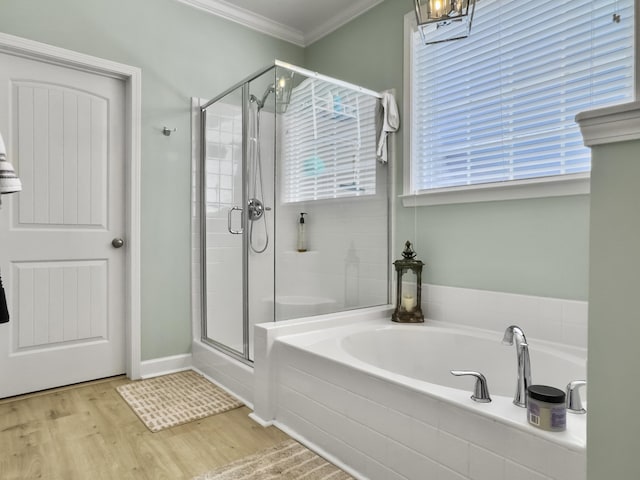 full bath with crown molding, a bath, a shower stall, and wood finished floors