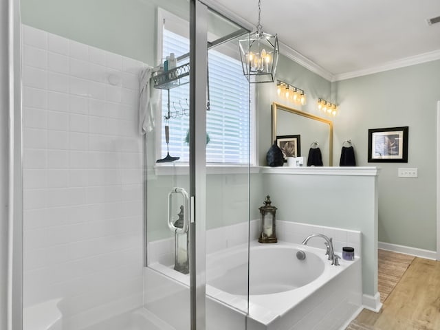 full bathroom featuring an inviting chandelier, crown molding, wood finished floors, a stall shower, and a garden tub