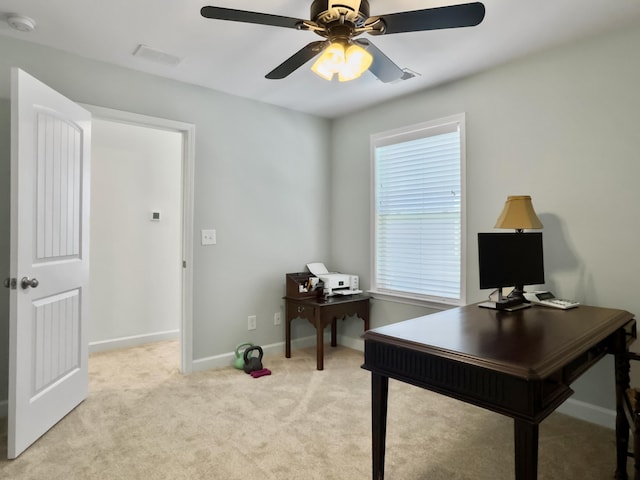 office area with light carpet, visible vents, baseboards, and a ceiling fan
