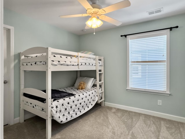 bedroom with visible vents, baseboards, multiple windows, and carpet
