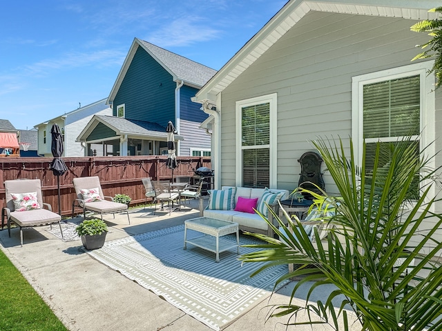 view of patio / terrace with an outdoor living space and fence