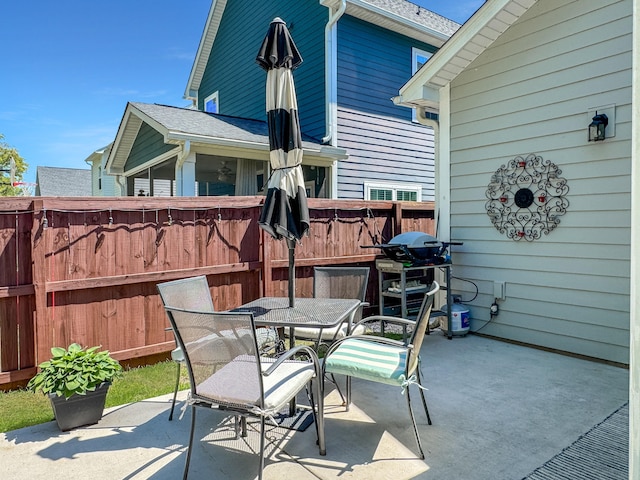 view of patio featuring fence and outdoor dining area