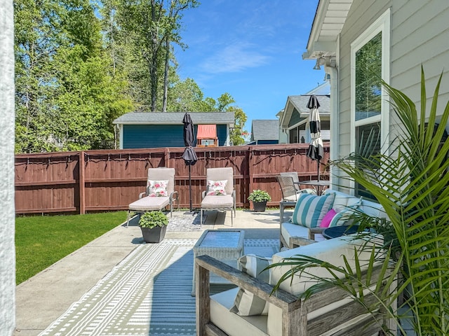 view of patio featuring fence and an outdoor hangout area
