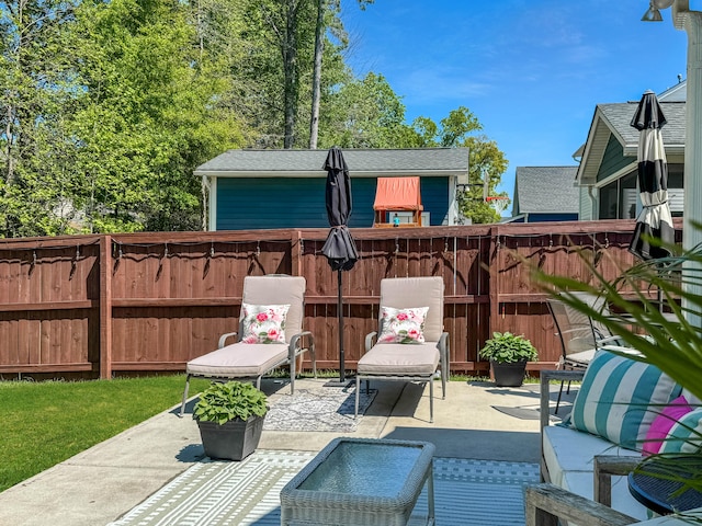 view of patio / terrace featuring an outdoor hangout area and fence