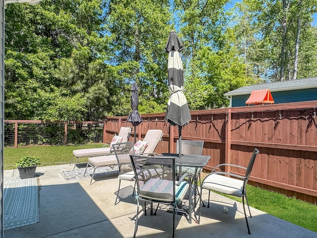 view of patio / terrace with outdoor dining space and fence