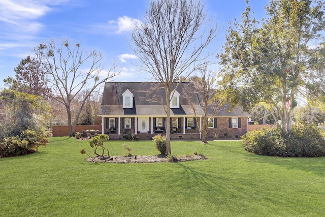 cape cod house featuring crawl space, a porch, a front lawn, and brick siding