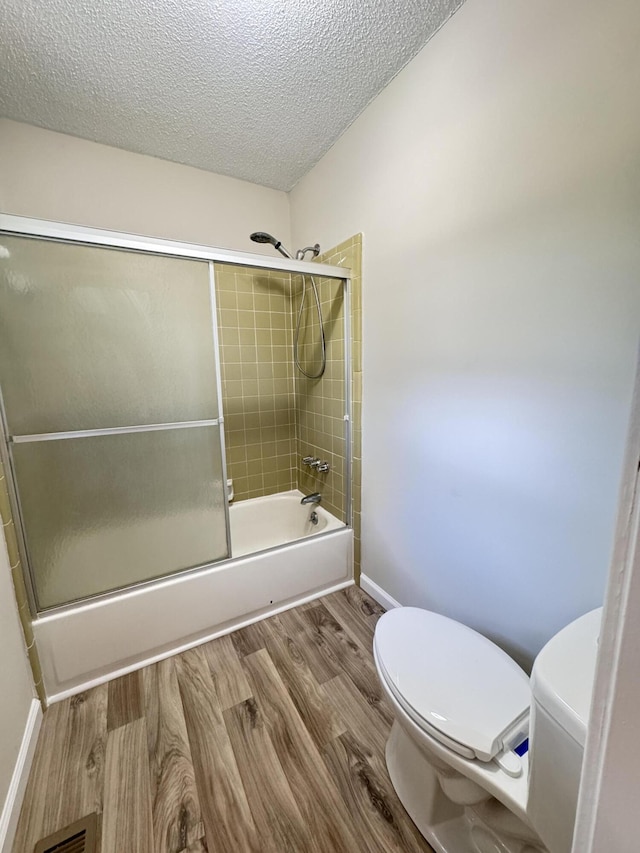 449 Estates Dr, Walterboro, SC 29488 - bathroom with combined bath / shower with glass door, wood finished floors, and a textured ceiling