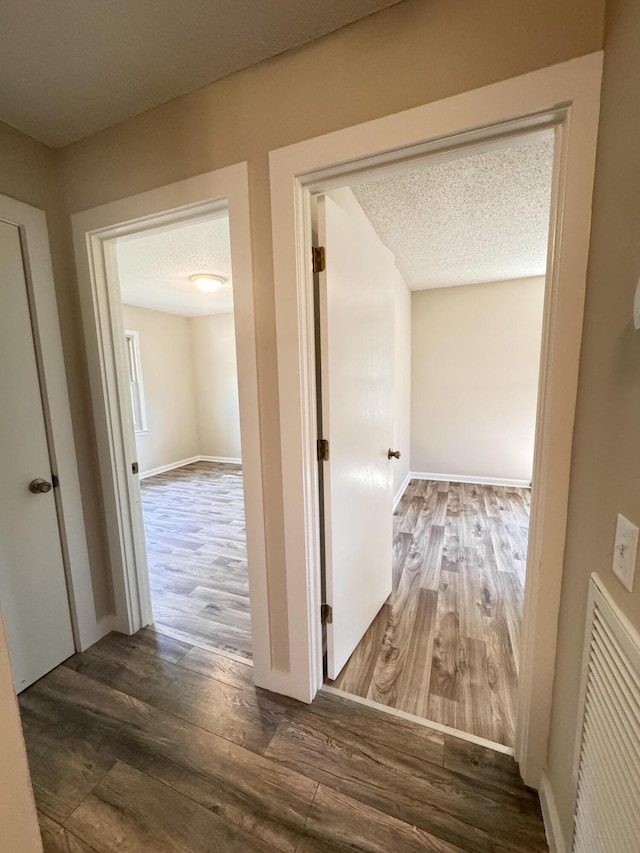 449 Estates Dr, Walterboro, SC 29488 - hallway with wood finished floors and a textured ceiling