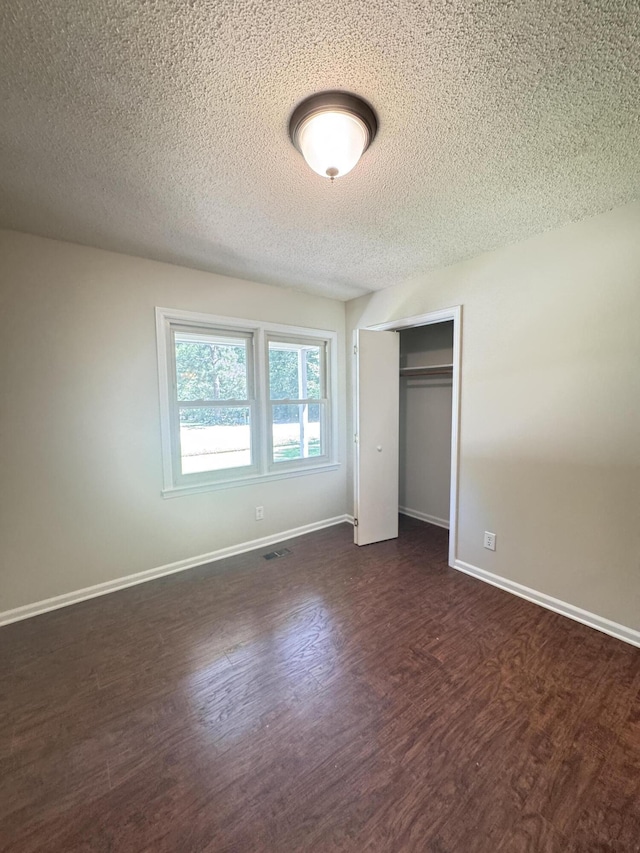 449 Estates Dr, Walterboro, SC 29488 - unfurnished bedroom with a textured ceiling, dark wood-style flooring, and a closet